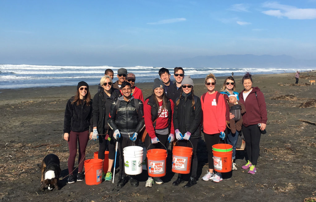 Some Asanas participating in a beach cleanup at Ocean Beach.