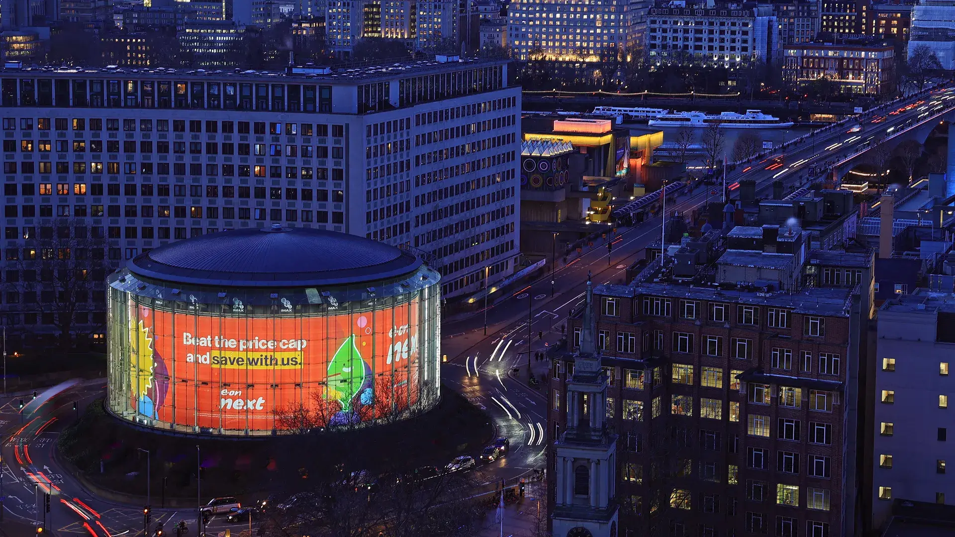 Photography showing a lit-up building with E.ON Next branding