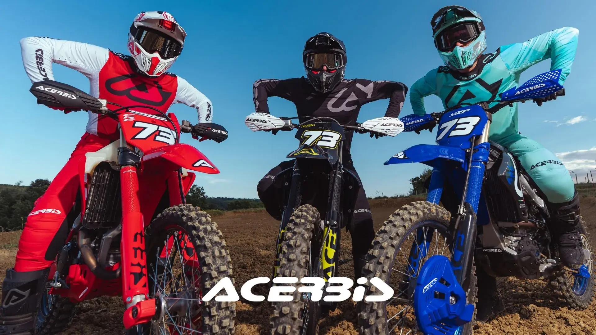 Three motocross riders showcase Acerbis riding gear in red, black, and teal. Fully kitted with Acerbis helmets, goggles, jerseys, and handguards on their #73 dirt bikes. Perfect shot for off-road, motorsport, and dirt bike enthusiasts on a sunny dirt track