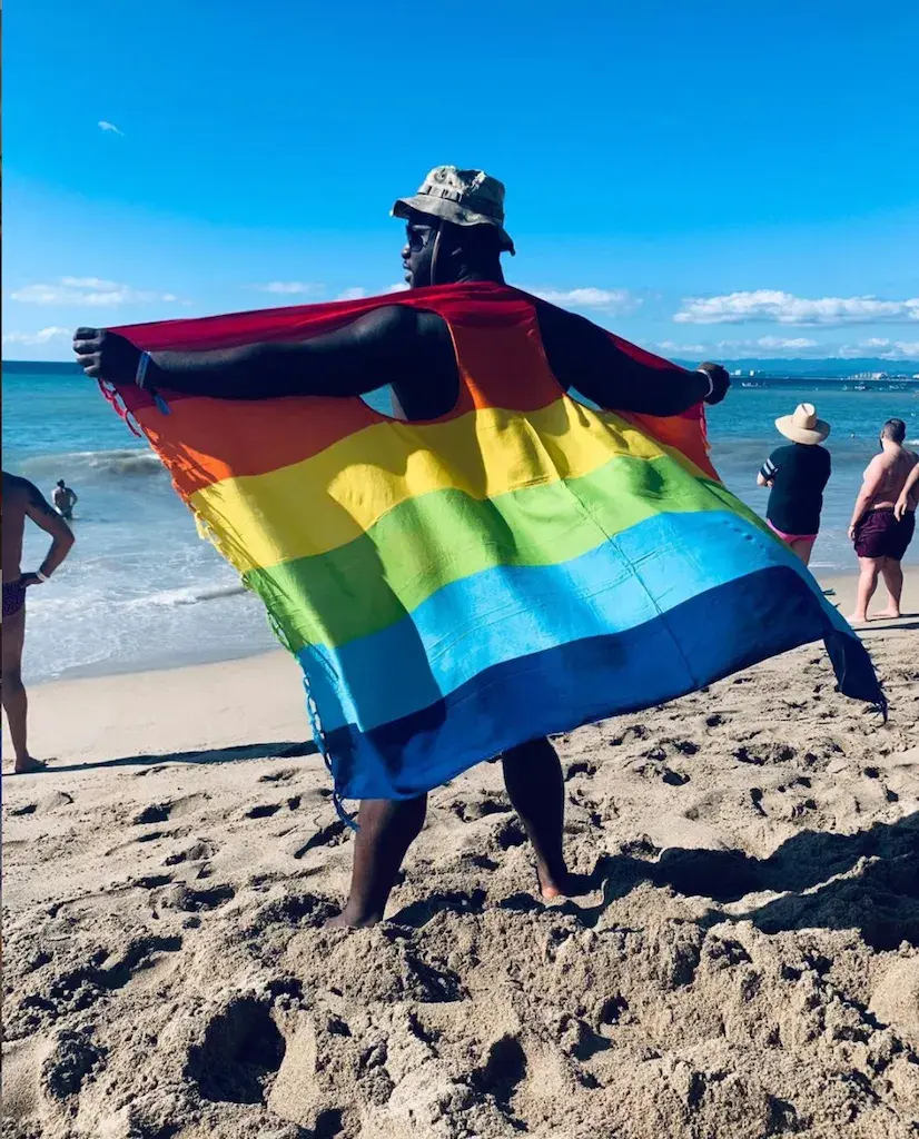 Image of Sebastian Gibson with Pride flag